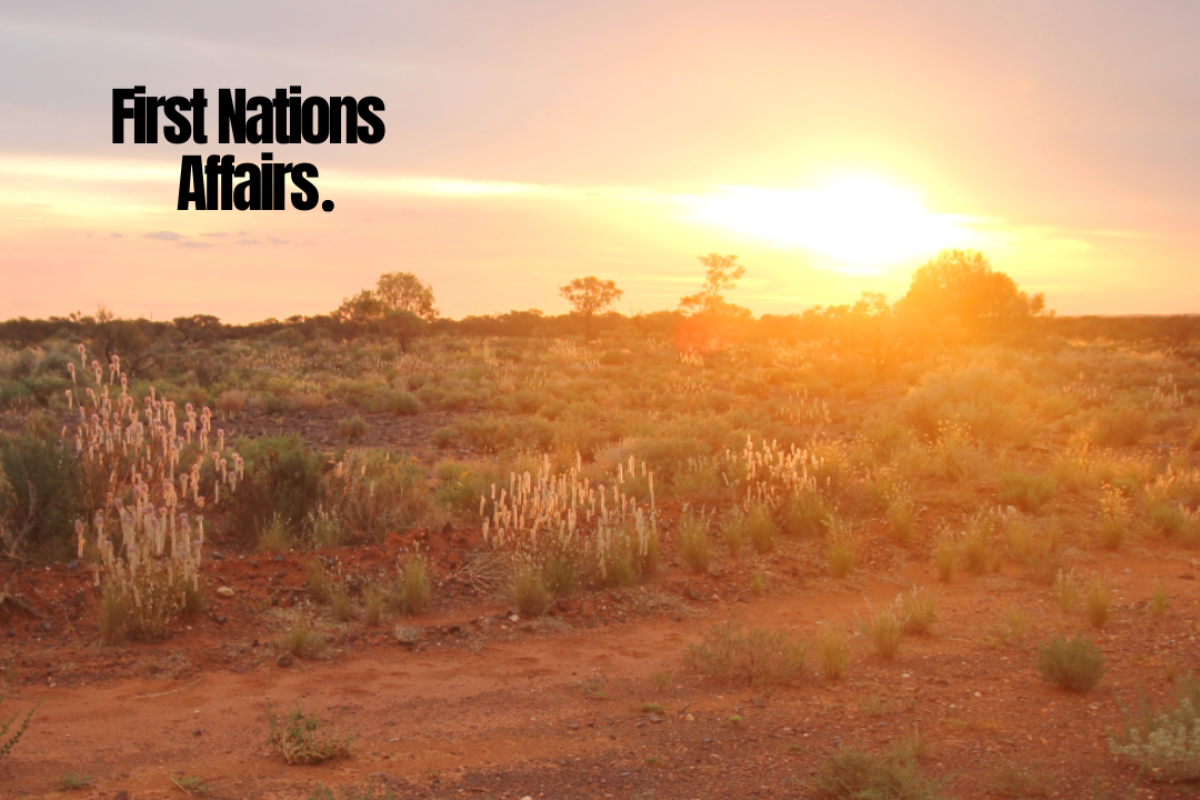 Sunset over an Australian outback landscape with red earth, native grasses, and the text “First Nations Affairs” in bold black font.